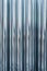 Background. Wavy foil made of glossy metal . Building materials, mirror corrugation sheet