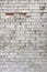 Background weathered brick wall with white plastering