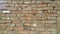 A background of a weathered old exterior brick wall in the sunshine