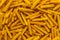Background of wheat and corn chips with a taste of cheese in the form of sticks
