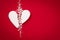 Background with white broken styrofoam heart on a red backdrop