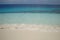 Background white sand beach and ocean with glassy water with different shades of blue