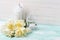 Background with white tulips, narcissus and candles.