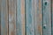 Background of wooden boards with old paint and vertical slats. Close-up view with bright lighti