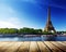 Background with wooden deck table and Eiffel tower