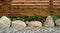 Background of a wooden fence and a path made of stones