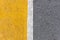 Background of yellow black strips . Dark grey asphalt road dividBackground of yellow black strips . Dark grey asphalt road divided