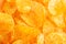 Background of yellow golden grooved fried potato chips
