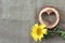 Background with yellow sunflower and wooden heart on the canvas