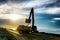 Backhoe or digger working with bucket at industrial earth excavation site