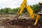 Backhoe Digging Into The Dirt