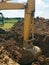 Backhoe digging a hole for house construction