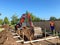 A backhoe digging a hole for a pool behind a house in Orlando, Florida