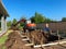 A backhoe digging a hole for a pool behind a house in Orlando, Florida