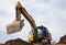 backhoe digging hydraulic shovel on construction site earth mover excavator dumping earth