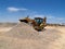 Backhoe Dumping Gravel