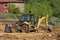 Backhoe excavating earth in a construction site