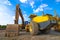 Backhoe, grader and road roller on the ground at site construction