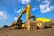 Backhoe, grader and road roller on the ground at site construction