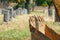 Backhoe in a graveyard with tombstones in the background