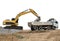 Backhoe heavy machine scoop rock to truck