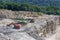 A backhoe and large truck work in the gypsum quarry in the summer.