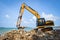 Backhoe loader digger excavator stone working construction site on the beach sea ocean