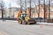 Backhoe loader stands on the street during road repair work