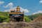 Backhoe at rest on top of dirt hill at construction site