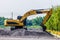 Backhoe standing on stone