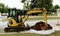 Backhoe on upscale neighborhood street