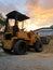 The backhoe is used for loading rocks, soil or sand in construction or agriculture work. Taken it in sunset time.