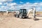 Backhoe working at a construction site. Machinery with two blades