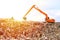 Backhoe working on garbage dump in landfill. People Working at Landfill site