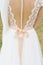 Backless wedding bridesmaid dress with lots of buttons and beige bow