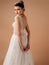 Backless wedding dress. Fashionable bridal gown with tender french lace and beads, long tulle skirt. Modern design. Beautiful brun