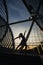 Backlight image of a woman dancing ballet on a bridge