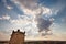 Backlit clouds at sunset with church tower