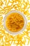 Backlit dried raw, uncooked spirelli pasta noodles in glass cont