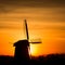 Backlit Dutch windmill during sunrise