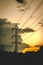 Backlit electricity tower at sunset with clouds