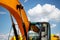 Backlit excavator on an industrial site against the background of the evening sky. Construction machinery for earthworks