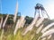 Backlit grass and cargo lift equipment on a hill.