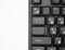Backlit keyboard close up. Black keys with illuminated characters