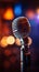 Backlit microphone close up with out of focus stage lights, musical ambiance captured