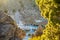 Backlit, natural framed scene of the Hot Creek Geological Site, focus on the teal water