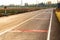 Backlit paved road with symbols on the countryside