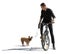 Backlit photo of a man riding a bike with his dog