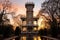 backlit photograph of an italianate tower at sunrise