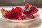 Backlit pieces of splitted pomegranate fruit at selective focus